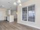 Bright dining area with hardwood floors, large windows, and a kitchen view at 1928 Shadow Glen Dr, Raleigh, NC 27604