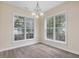 Dining room featuring hardwood floors, multiple large windows, and a chandelier at 1928 Shadow Glen Dr, Raleigh, NC 27604