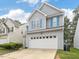 Charming two-story home with gray siding, white trim, blue shutters, and a two-car garage at 1928 Shadow Glen Dr, Raleigh, NC 27604