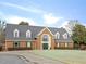 Traditional brick home with dormer windows, green shutters and meticulously maintained landscaping at 1928 Shadow Glen Dr, Raleigh, NC 27604