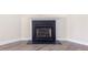 Bright living space with a black fireplace and mantel, complete with modern wood-look floors at 1928 Shadow Glen Dr, Raleigh, NC 27604