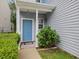 Inviting blue front door framed by white columns and a well-manicured garden at 1928 Shadow Glen Dr, Raleigh, NC 27604