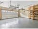 Spacious garage with painted floors, overhead storage and shelving units at 1928 Shadow Glen Dr, Raleigh, NC 27604