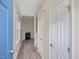 Bright hallway with hardwood floors leading to a living area with fireplace at 1928 Shadow Glen Dr, Raleigh, NC 27604