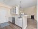 Kitchen with white cabinets and modern stainless-steel appliances, open to the living area at 1928 Shadow Glen Dr, Raleigh, NC 27604