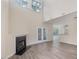 Spacious living room with hardwood floors, fireplace, and French doors at 1928 Shadow Glen Dr, Raleigh, NC 27604