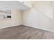 Spacious, light-filled living room with a modern staircase and wood-look flooring throughout at 1928 Shadow Glen Dr, Raleigh, NC 27604