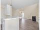 Open living area with a fireplace and view into kitchen with white counters and bar seating at 1928 Shadow Glen Dr, Raleigh, NC 27604
