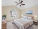 Staged main bedroom with vaulted ceiling, ceiling fan, and a large window at 1928 Shadow Glen Dr, Raleigh, NC 27604