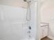 Shower with white tile surround at 1928 Shadow Glen Dr, Raleigh, NC 27604