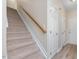 Carpeted staircase with wood railing, leading to the upper level of the home at 1928 Shadow Glen Dr, Raleigh, NC 27604