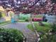 Landscaped backyard features a stone firepit, a blue chair, and a brick pathway at 1930 Briar Chapel Pkwy, Chapel Hill, NC 27516