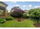 Landscaped backyard featuring a stone patio and green space at 1930 Briar Chapel Pkwy, Chapel Hill, NC 27516