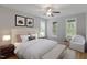 Inviting bedroom with soft lighting, neutral tones, and large windows at 1930 Briar Chapel Pkwy, Chapel Hill, NC 27516