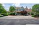 Large clubhouse featuring a brick drive, covered entry and patio and mature landscaping at 1930 Briar Chapel Pkwy, Chapel Hill, NC 27516