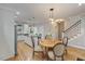 Bright dining room with hardwood floors, modern lighting, and a round wood table at 1930 Briar Chapel Pkwy, Chapel Hill, NC 27516