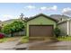 Two car garage with green paint, brown door, and driveway at 1930 Briar Chapel Pkwy, Chapel Hill, NC 27516