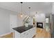 Bright kitchen with a black countertop island and open access to the living spaces at 1930 Briar Chapel Pkwy, Chapel Hill, NC 27516