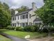 Charming two-story home with a well-manicured lawn and mature trees at 1930 Reid St, Raleigh, NC 27608