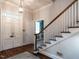 Inviting foyer with hardwood floors and staircase with white railings at 1930 Reid St, Raleigh, NC 27608
