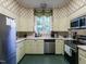 Bright kitchen featuring stainless steel appliances, light green cabinets, and a window view at 1930 Reid St, Raleigh, NC 27608