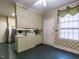 Spacious kitchen with stainless steel appliances, light green cabinets, and patterned wallpaper at 1930 Reid St, Raleigh, NC 27608