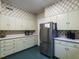 Classic kitchen features ample cabinet space, stainless steel appliances, and unique wallpaper at 1930 Reid St, Raleigh, NC 27608