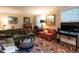 Comfortable living room with patterned rug, sofas, desk, and a TV at 1930 Reid St, Raleigh, NC 27608