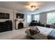 Spacious main bedroom with a fireplace, a ceiling fan, and windows at 1930 Reid St, Raleigh, NC 27608