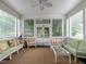 Bright and airy sunroom with lots of windows and comfortable furniture at 1930 Reid St, Raleigh, NC 27608