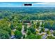 Aerial shot showcases the home's proximity to Durham, the surrounding area, and lush trees at 2 Donnelly Ct, Durham, NC 27713