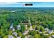 Aerial shot of home's proximity to Durham, showcasing neighborhood and surrounding trees at 2 Donnelly Ct, Durham, NC 27713