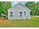 Rear exterior showcasing light siding and well-manicured lawn at 2 Donnelly Ct, Durham, NC 27713