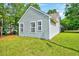 Backyard exterior featuring well-maintained lawn and light siding at 2 Donnelly Ct, Durham, NC 27713
