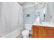 Bathroom featuring tub with shower curtain, sink and wire shelving at 2 Donnelly Ct, Durham, NC 27713