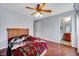 Bedroom features wood floors, fan, with view into bathroom at 2 Donnelly Ct, Durham, NC 27713