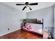 Bedroom with a ceiling fan and wooden floors features a bunk bed with grey frame and a decorative comforter at 2 Donnelly Ct, Durham, NC 27713
