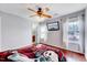 Bedroom features wood floors, fan, with two windows and view into the bathroom at 2 Donnelly Ct, Durham, NC 27713