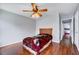 Bedroom with hardwood floors, fan, and view into another bedroom at 2 Donnelly Ct, Durham, NC 27713