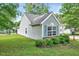 View of the home's exterior showcasing the siding, trim, manicured landscaping and well-kept lawn at 2 Donnelly Ct, Durham, NC 27713