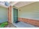 Inviting front entrance with a green door, brick accents, and well-maintained siding at 2 Donnelly Ct, Durham, NC 27713