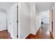 Bright hallway with hardwood floors leading into a living area with a fireplace at 2 Donnelly Ct, Durham, NC 27713