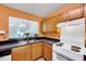 Cozy kitchen with classic wood cabinets and countertops featuring a pass-through to the living area at 2 Donnelly Ct, Durham, NC 27713