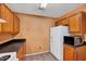 This cozy kitchen features wooden cabinets, black countertops, and essential appliances at 2 Donnelly Ct, Durham, NC 27713