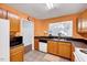 This kitchen offers wooden cabinets, black countertops, and an open view to the living area at 2 Donnelly Ct, Durham, NC 27713