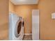 Functional laundry room with a washer, dryer, and storage at 2 Donnelly Ct, Durham, NC 27713