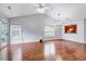 An open living room featuring hardwood floors, modern lighting, vaulted ceiling and a pass-through to the kitchen at 2 Donnelly Ct, Durham, NC 27713