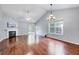 Bright living room featuring hardwood floors, fireplace, modern lighting, and sliding door to patio at 2 Donnelly Ct, Durham, NC 27713