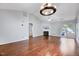 Open living room with vaulted ceiling, fireplace, hardwood floors, modern lighting, and patio access at 2 Donnelly Ct, Durham, NC 27713