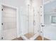 Bright bathroom showcasing a glass shower with white tiled walls, open to a closet and bedroom at 203 S South Bend Dr, Durham, NC 27713